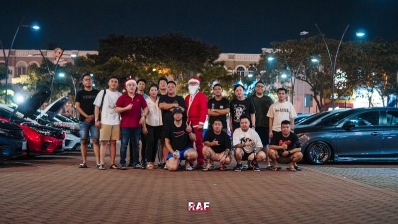 Danu with his car community at a night meet, modified cars lined up behind the group (photo: FAF Studios)